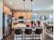 Modern kitchen featuring stainless steel appliances, granite countertops, and an island with bar seating at 7845 S Flat Rock Way, Aurora, CO 80016