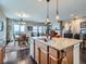Island seating in a spacious kitchen leads to views of the open-concept dining and living areas at 7845 S Flat Rock Way, Aurora, CO 80016