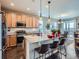 Kitchen with stainless steel appliances, granite counters, island seating, and an adjacent dining area at 7845 S Flat Rock Way, Aurora, CO 80016