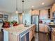 Bright kitchen with stainless steel appliances, granite countertops, island and open concept layout at 7845 S Flat Rock Way, Aurora, CO 80016