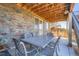 Outdoor patio with dining set and stone accents at 7845 S Flat Rock Way, Aurora, CO 80016