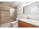 Well-lit bathroom featuring a tiled shower with glass door, modern fixtures, and an updated vanity for a clean, fresh feel at 350 S Clinton St # 2A, Denver, CO 80247