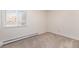 Inviting bedroom featuring neutral carpeting and a large window offering ample natural light, creating a cozy and relaxing space at 350 S Clinton St # 2A, Denver, CO 80247