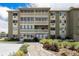 Exterior of building with enclosed balconies, manicured landscaping, and inviting entrance at 350 S Clinton St # 2A, Denver, CO 80247