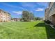 Expansive lawn area between residential buildings under a clear blue sky at 350 S Clinton St # 2A, Denver, CO 80247
