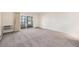 Bright, carpeted living room with sliding doors for ample natural light and ventilation at 350 S Clinton St # 2A, Denver, CO 80247