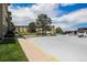 Well maintained parking lot with parking spaces and sidewalks next to lawn area at 350 S Clinton St # 2A, Denver, CO 80247