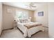 Cozy bedroom features neutral tones, plush bedding, and bright natural light from the windows at 11302 W Prentice Dr, Littleton, CO 80127