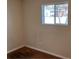 Simple bedroom with window, brown carpet, and neutral walls at 1550 Ash Ct, Thornton, CO 80229