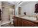 Bathroom featuring double sink vanity, tiled walk-in shower with glass door, and shuttered window at 3748 Starry Night Loop, Castle Rock, CO 80109