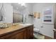 Bathroom with wooden vanity and a mirror with decorative accents at 3748 Starry Night Loop, Castle Rock, CO 80109