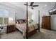 Bedroom featuring four poster bed, wood furniture, neutral carpet, and tray ceiling with fan at 3748 Starry Night Loop, Castle Rock, CO 80109