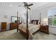 Cozy bedroom with a four-poster bed, neutral carpet and white shutters at 3748 Starry Night Loop, Castle Rock, CO 80109