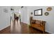 Bright entryway with shiny hardwood floors, white walls, and wood bench with colorful pillows at 3748 Starry Night Loop, Castle Rock, CO 80109