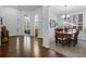Inviting entryway with dark wood floors, leading to a dining room and bedroom at 3748 Starry Night Loop, Castle Rock, CO 80109