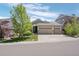 Charming home with well-manicured lawn, mature tree, and a spacious three-car garage at 3748 Starry Night Loop, Castle Rock, CO 80109