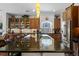 Kitchen island with granite countertop, a stainless steel sink, faucet and stainless steel refrigerator at 3748 Starry Night Loop, Castle Rock, CO 80109