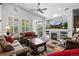 Bright living room featuring a ceiling fan, fireplace, and sliding glass door to the backyard at 3748 Starry Night Loop, Castle Rock, CO 80109