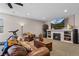 Inviting living room with fireplace, large-screen TV, and plush leather seating at 3748 Starry Night Loop, Castle Rock, CO 80109