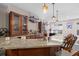 A wet bar featuring granite countertops, custom cabinets, and seating creating an ideal space for entertaining guests at 3748 Starry Night Loop, Castle Rock, CO 80109