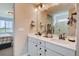 Bright bathroom featuring double vanity with stone countertops and a view from the adjacent bedroom at 1839 Morgan Dr, Erie, CO 80516