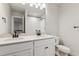 Well-lit bathroom with a double vanity, modern fixtures, and a toilet at 1839 Morgan Dr, Erie, CO 80516