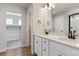 Bright bathroom featuring a double vanity with modern fixtures and a walk-in closet at 1839 Morgan Dr, Erie, CO 80516