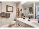 Bathroom featuring double vanity with stone countertops, neutral paint, and framed art on the walls at 1839 Morgan Dr, Erie, CO 80516