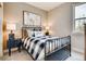 Cozy bedroom with a metal-frame bed, plaid bedding, and coordinated nightstands for a restful retreat at 1839 Morgan Dr, Erie, CO 80516