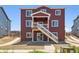 Exterior of house with red siding, multiple windows and balcony at 1839 Morgan Dr, Erie, CO 80516