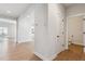 Hallway with hardwood floors leading to the kitchen and a bathroom at 1839 Morgan Dr, Erie, CO 80516
