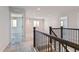 Upstairs hallway showcasing railing and access to rooms at 1839 Morgan Dr, Erie, CO 80516