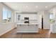 Modern kitchen featuring stainless steel appliances, a large island, and ample cabinet space at 1839 Morgan Dr, Erie, CO 80516