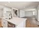 Open kitchen featuring a center island with stainless steel dishwasher and white cabinets at 1839 Morgan Dr, Erie, CO 80516