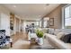 Open-concept living room with hardwood floors connecting to the kitchen and dining area at 1839 Morgan Dr, Erie, CO 80516