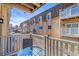 View from balcony showing seating area and adjacent apartment building at 7375 E Quincy Ave # 202, Denver, CO 80237