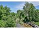 Creek in park surrounded by lush green trees and rocks at 7375 E Quincy Ave # 202, Denver, CO 80237