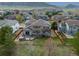 Aerial view of the backyard, showing a deck with a hot tub, wood fence, and mountain views at 9362 S Holland Way, Littleton, CO 80127