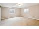 Spacious carpeted basement room with two windows providing natural light at 9362 S Holland Way, Littleton, CO 80127