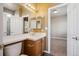 Bathroom featuring a vanity with a mirror, a toilet, and an open doorway to another room at 9362 S Holland Way, Littleton, CO 80127