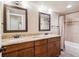 Bathroom featuring double sinks, granite countertop, and a tiled shower with glass door at 9362 S Holland Way, Littleton, CO 80127