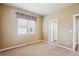Cozy bedroom with neutral walls, plush carpet, and a bright window for natural light at 9362 S Holland Way, Littleton, CO 80127