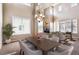 Bright formal dining room with high ceilings, fireplace, and large windows at 9362 S Holland Way, Littleton, CO 80127