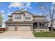 Charming two-story home with a three-car garage and manicured front lawn at 9362 S Holland Way, Littleton, CO 80127