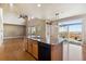 Open concept kitchen features an island with granite countertops, with exterior views at 9362 S Holland Way, Littleton, CO 80127