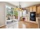 Bright kitchen with a sliding glass door leading to outdoor hot tub on the deck at 9362 S Holland Way, Littleton, CO 80127
