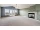 Open living room with high ceilings, a fireplace, and balcony access at 9362 S Holland Way, Littleton, CO 80127