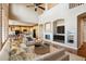 Open living space featuring hardwood floors, a fireplace, and seamless access to the kitchen at 9362 S Holland Way, Littleton, CO 80127