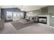 Spacious main bedroom featuring a fireplace, windows with a balcony and neutral decor at 9362 S Holland Way, Littleton, CO 80127