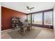 Stylish home office with large windows, desk, ceiling fan, and decorative shelving at 9362 S Holland Way, Littleton, CO 80127